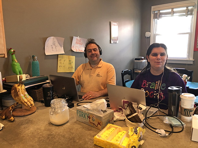 Mark Riccobono and Karen Anderson work on their laptops.